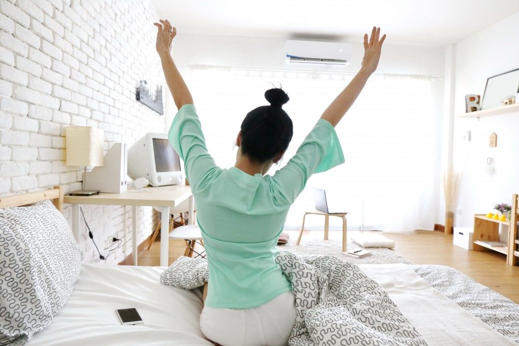 Woman stretching on her bed