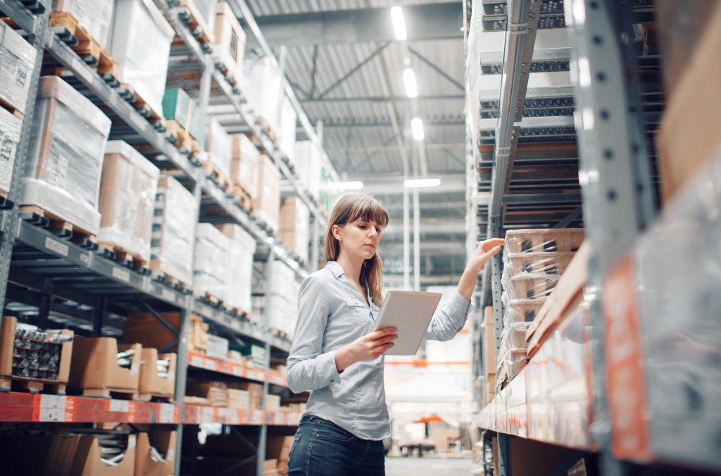 Woman checking storage in warehouse