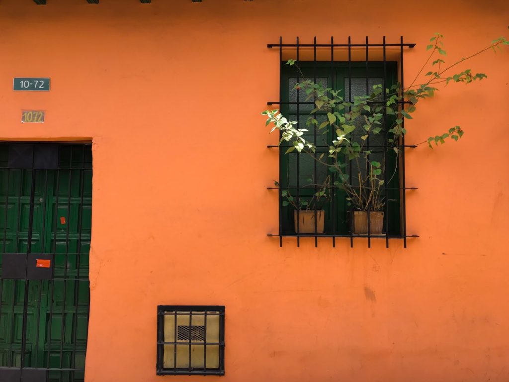 orange house with window bars