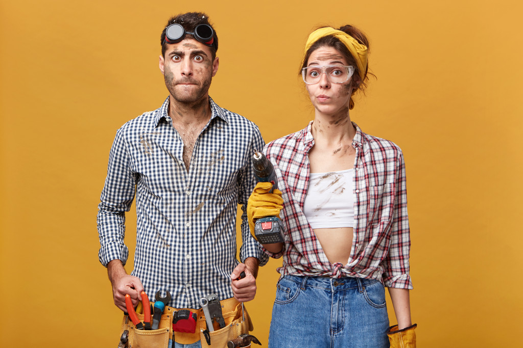 man and woman in construction clothing