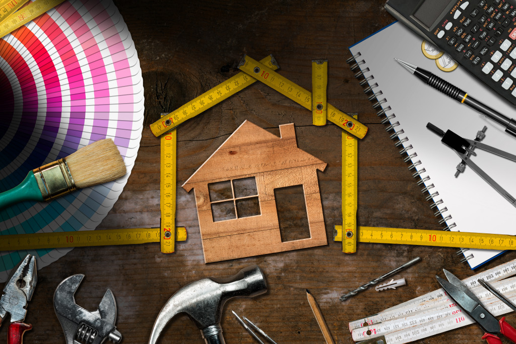 a house sketch with renovation tools