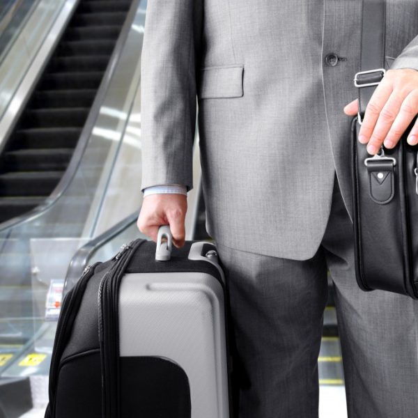 a traveling businessman carrying luggages