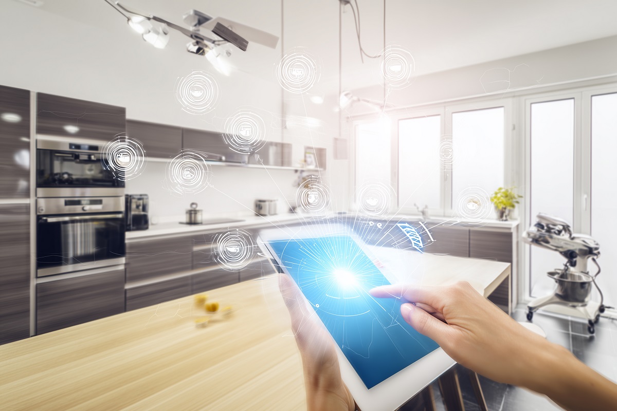 close-up of a person using a tab in a modern kitchen